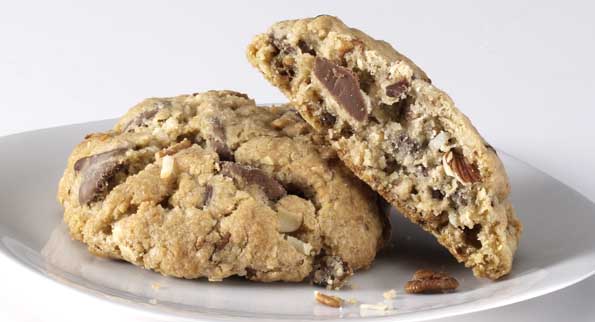 A scrumptious Kitchen Sink cookie, loaded with nuts, chocolates, and oats.
