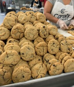 Baker making fresh homemade cookies at Carol's Cookies